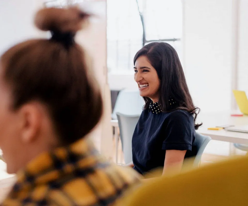 Two women in office having a discussion